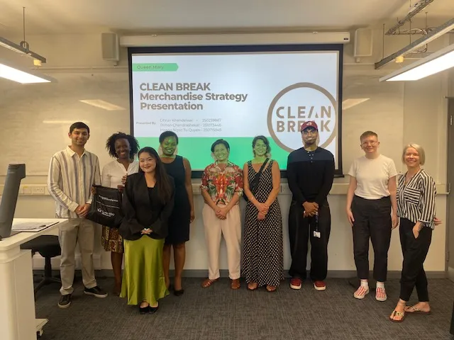 Group photo of students presenting their projects in front of projector