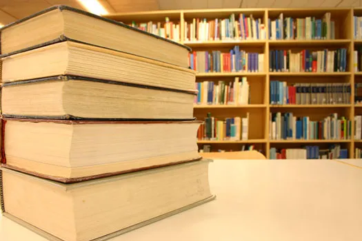 Books arranged on a table in a library