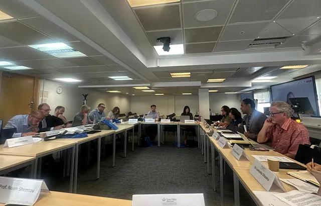 Participants at the QMIPRI evergreening workshop. The desks are arranged so participants are facing inwards.