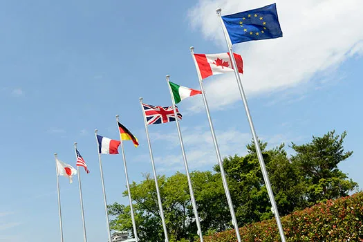G7 flags on poles. Left to right: Japan, USA, France, Germany, UK, Italy, Canada and EU