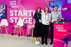 qLegal's Emily Wapples and Eliza Platts-Mills on a podium at Legal Tech Week with Tom Bohills, Founder and Principal at Founders Law.
