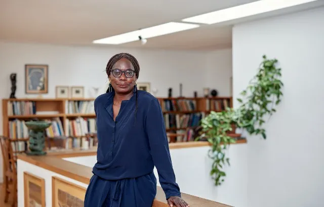 Professor Phoebe Okowa standing in a library
