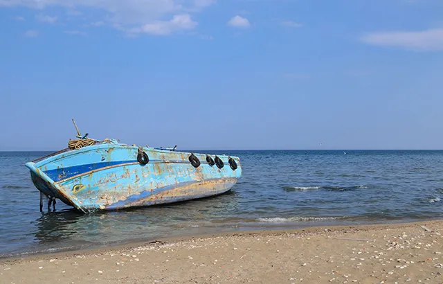 A boat that carried refugees abandoned on a beach.