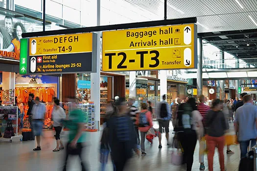 People walking through the departure lounge of an airport