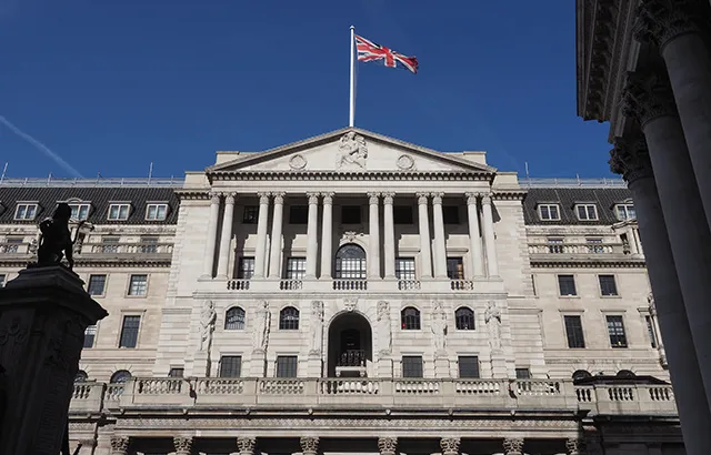 The front of the Bank of England building.It had columns and a pole with the Union Jack flying on it.