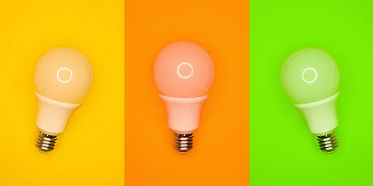 Three light bulbs on yellow, orange and green backgrounds