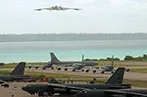 B-2 bomber taking off and B-52 bombers on the tarmac at the Diego Garcia Naval Support Facility, Chagos Archipelago in 2003.