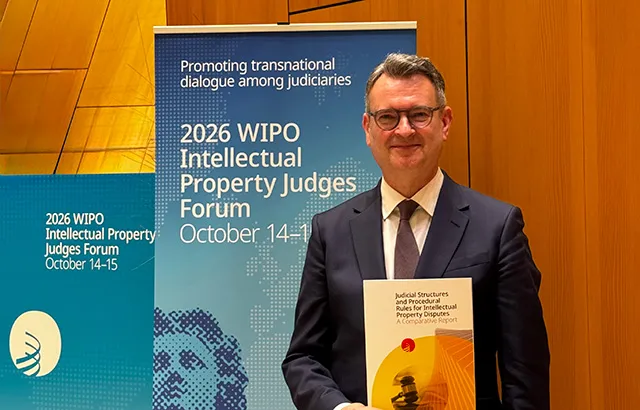 Duncan Matthews standing at WIPO with a copy of his new report.