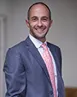Ioannis Kokkoris wearing a suit and pink tie