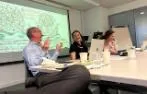 Raphaële Garrod and Julie Stone-Peters speaking with Greg Walker with medieval artwork on a slide behind them.