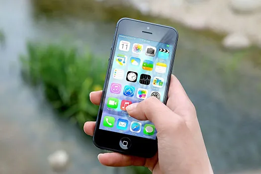 Person's hand holding an iphone