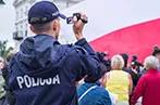 A police officer holding a video camera recording