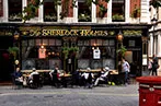 Patrons sat outside the Sherlock Holmes pub in London
