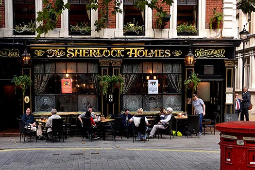 People sitting outside the Sherlock Pub in London