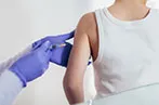 A doctor administering an injection to a patient