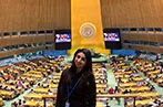 A student standing in front of an auditorium