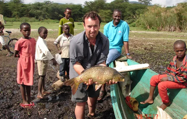 Dr Jonathan Grey, with a common carp caught by local fishermen. Despite having been introduced into Lake Naivasha only 10 years ago, carp now dominates the fishery return, and is indicative of the degraded water quality of the lake.