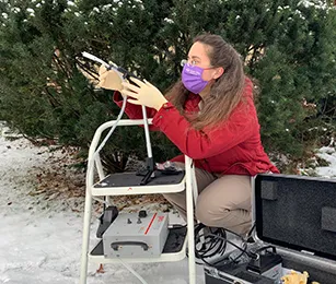 Elizabeth Clare crouching down to sample air