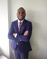 Nuel Oji wearing a blue suit