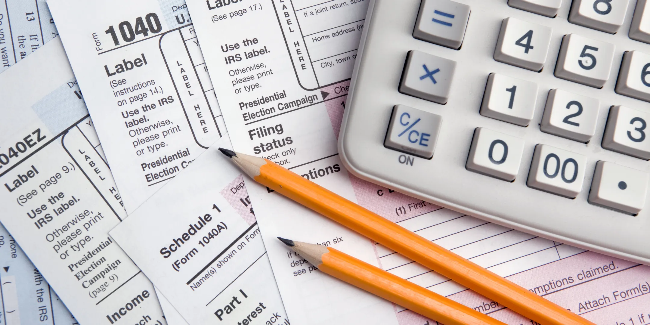 Tax sheets with calculator and pencils