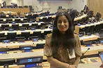 Professor Miriam Goldby in the chamber of UNCITRAL, with seats of different countries behind her.