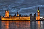 Landscape image of the UK Houses of Parliament at night.