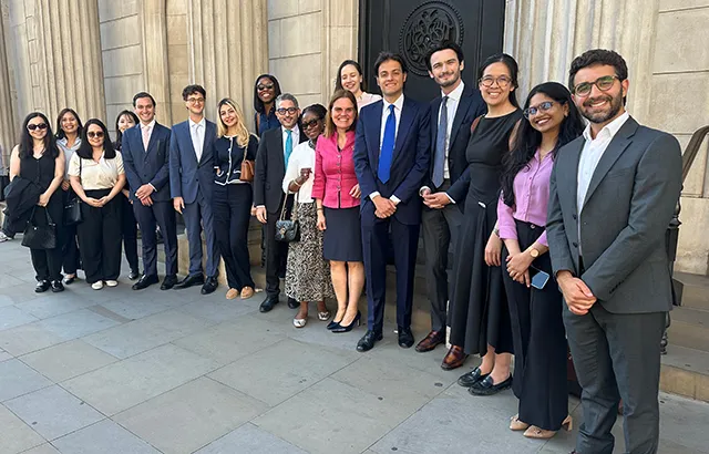 Professor Rosa Lastra and Dr Daniele D'Alvia with Queen Mary LLM students standing by a door to the Bank of England.