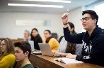 Queen Mary LLB student with raised hand in lecture