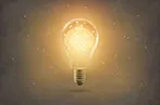 Lightbulb emitting a yellow light with a brain inside