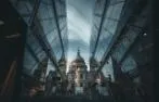 A view of St Paul's Cathedral between two glass office buildings.