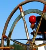 Ship wheel against a blue sky