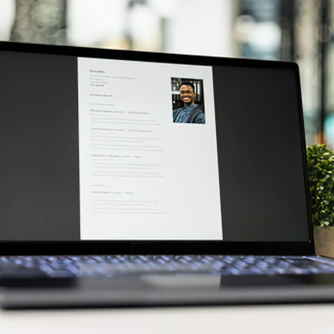 A laptop with someones CV on screen