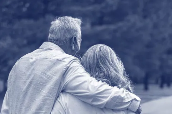 Two people with their arms around each other