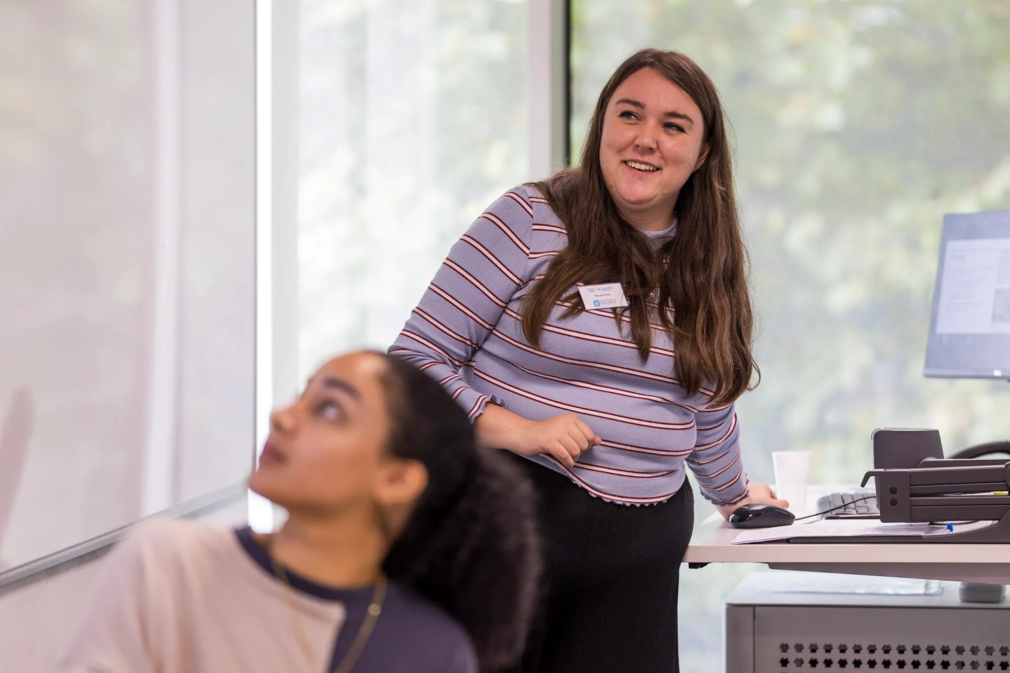 Photo of Micaela Panes presenting at the Mile End Institute's Breaking the Glass Chamber conference. The photo also features Olivia Wyatt and was taken by Gary Schwartz in September 2022