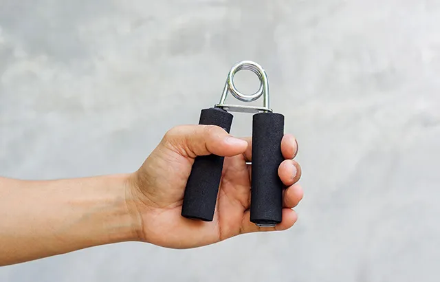 Man use handgrips for exercise