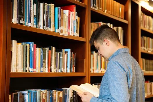 History student in library with book