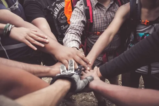 Group of arms and hands in a huddle on top of each other