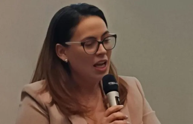 Maria Fanou speaking into a microphone.