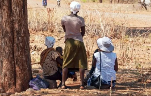 Three women with a child in a rural setting in Zimbabwe