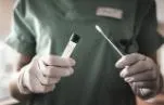 Nurse holds swab for coronavirus test. Small