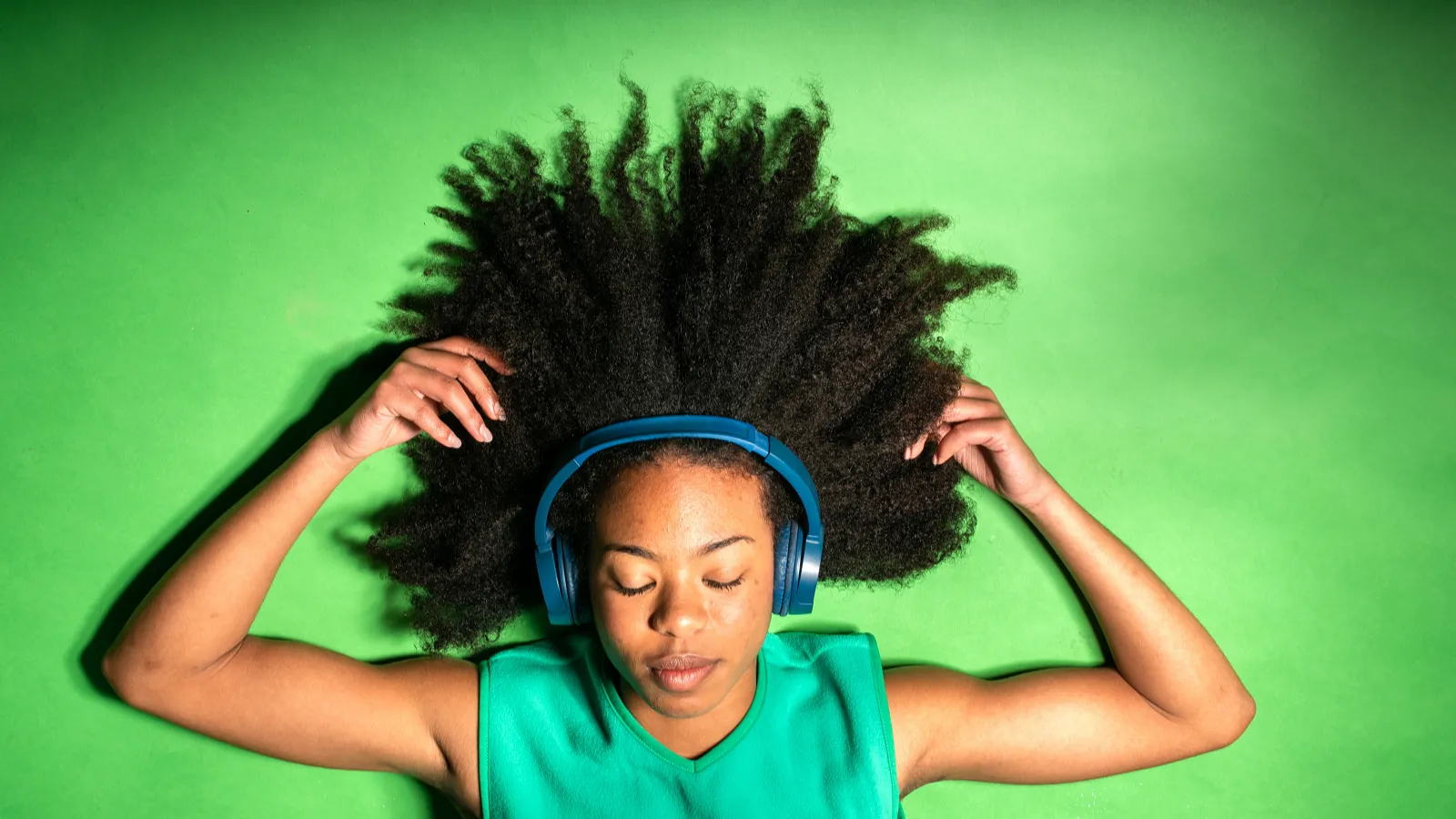 Person lying down with headphones on