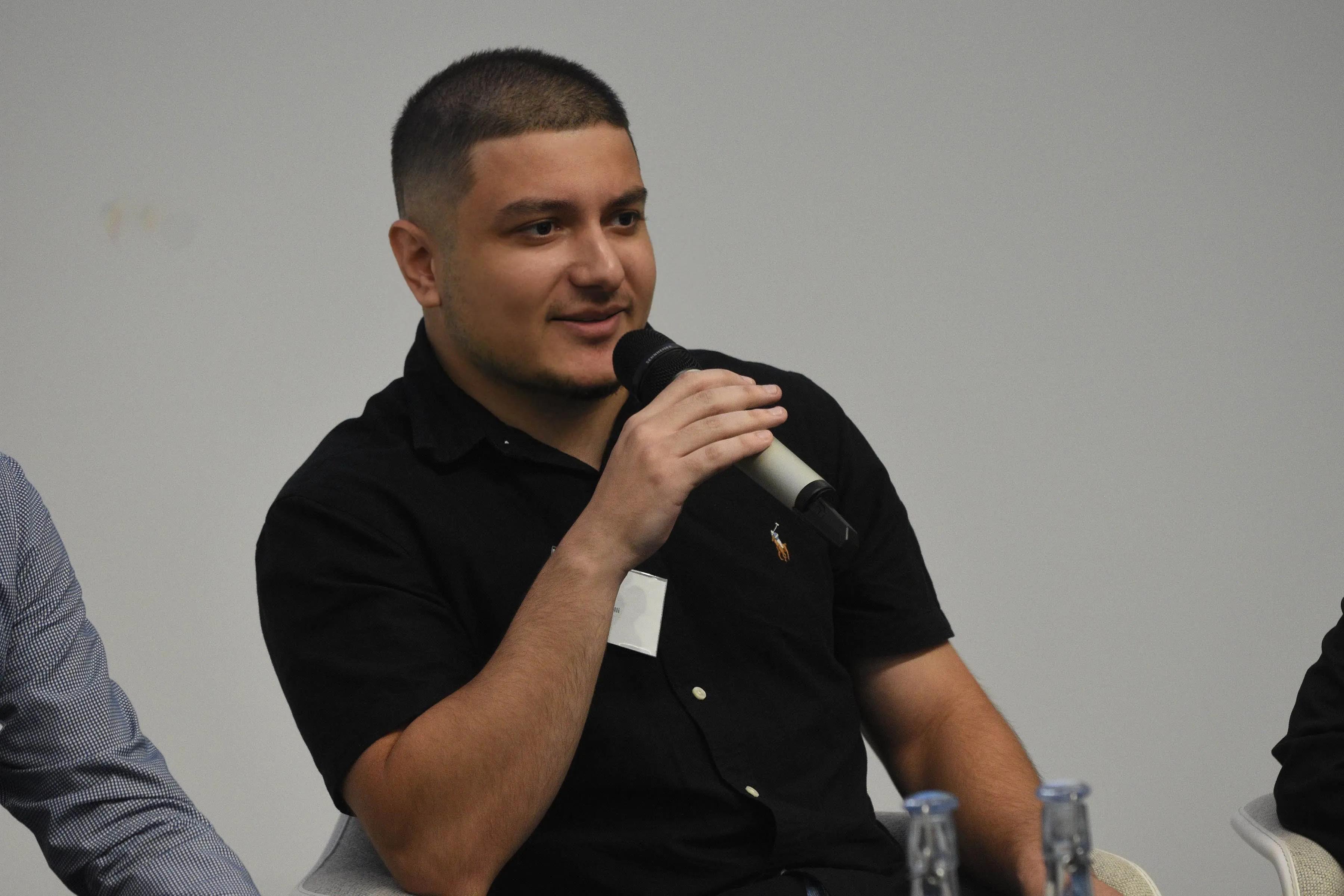 EECS alumni talking in a microphone