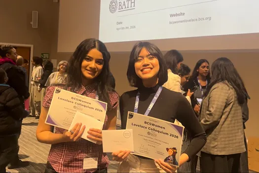 Two students holding a certificate at programming conference