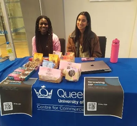 Two students sitting at a table for the Social Justice Policy Clinic Pop-up consultation workshop