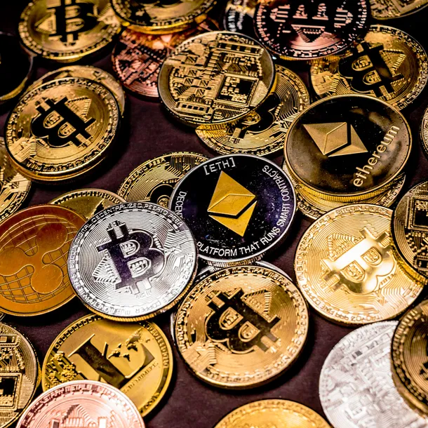 Assortment of gold and silver coins with Bitcoin symbols on them