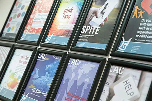 Posters of projects offered by the LAC hanging on the wall