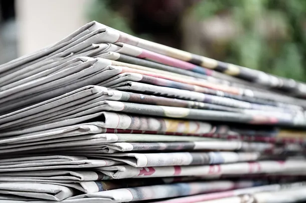 Pile of folded newspapers