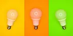 Three light bulbs on yellow, orange and green backgrounds