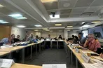Participants at the QMIPRI evergreening workshop. The desks are arranged so participants are facing inwards.