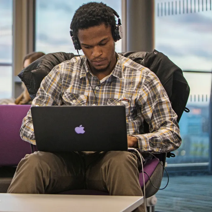 Male Student working on Laptop